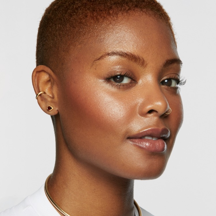 Portrait shot of a model wearing Milk Makeup products on a white background