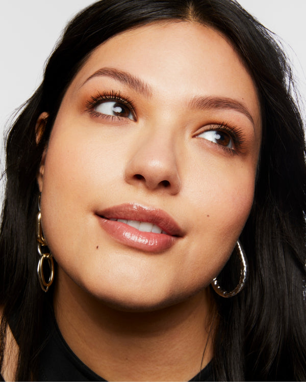 Portrait of Milk Makeup model Vanessa looking off to the side on a white background